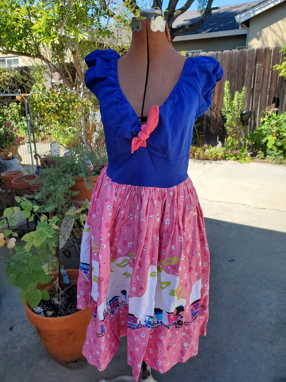 Pinup Couture Mary Blair Blue Bodice Pink Printed Skirt Dress with Coral Tie